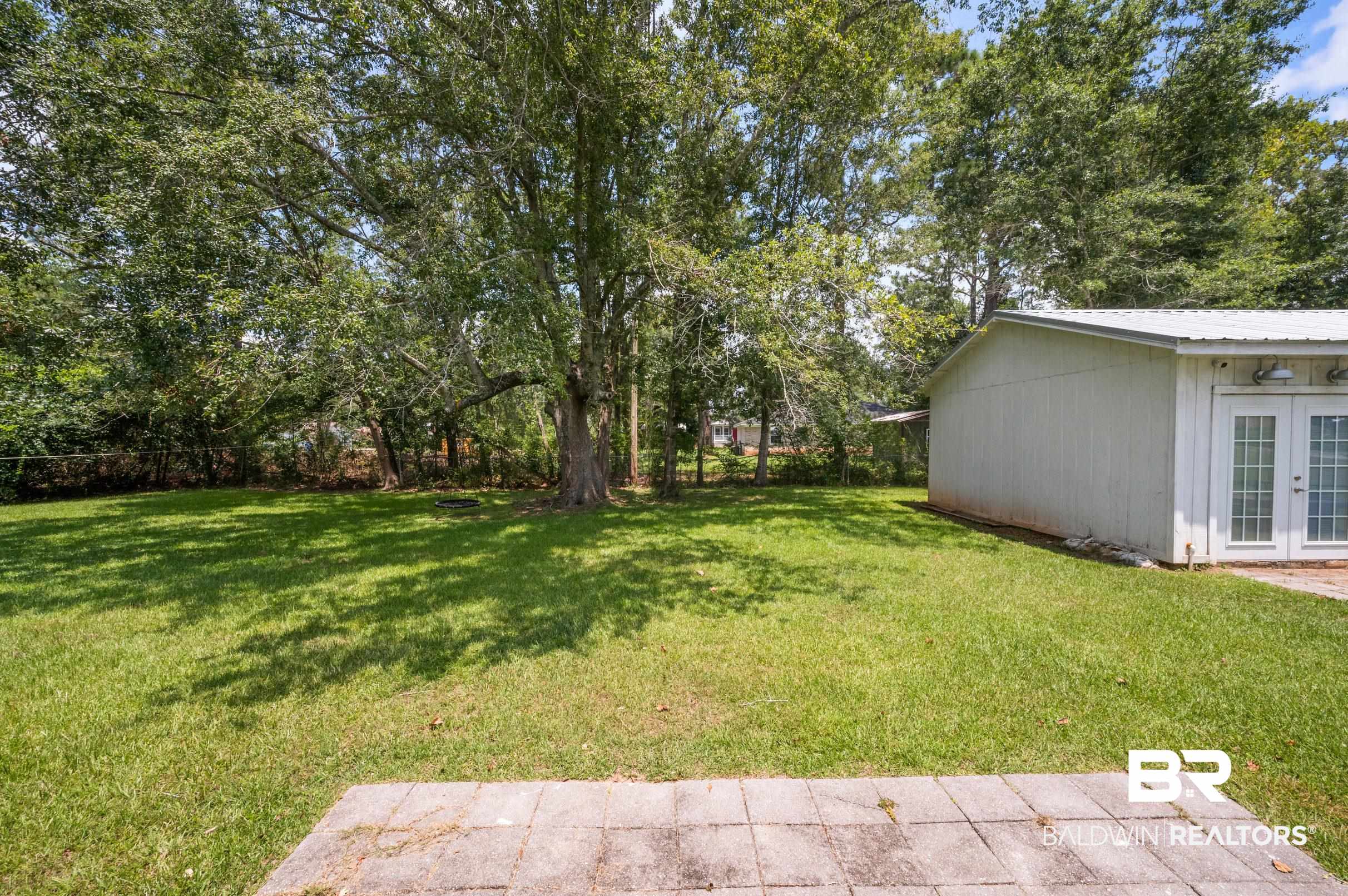 24663 Chestnut Street Elberta, AL 36530 - Photo 21 of 22 Expansive lawn area featuring mature trees providing natural shade