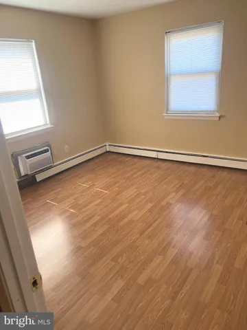 a view of a room with wooden floor and a window