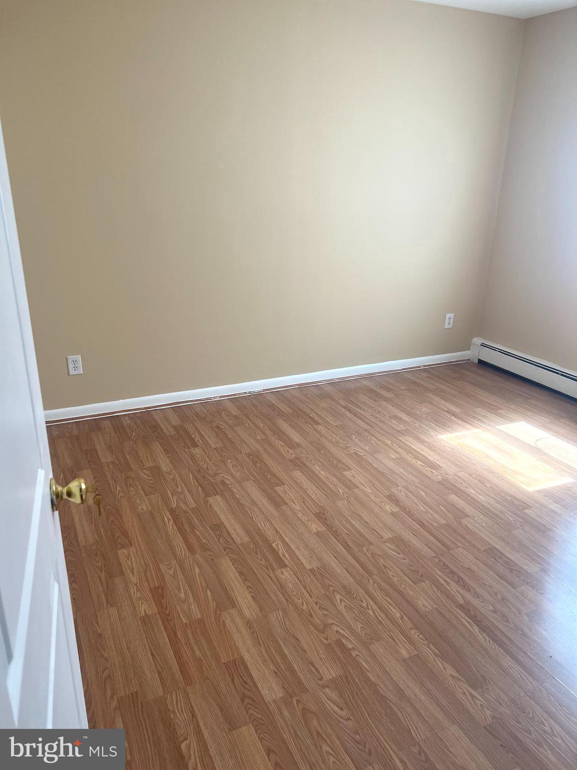 4001 29th Street, Unit 202 Mount Rainier, MD 20712 - Photo 4 of 7 a view of an empty room with wooden floor