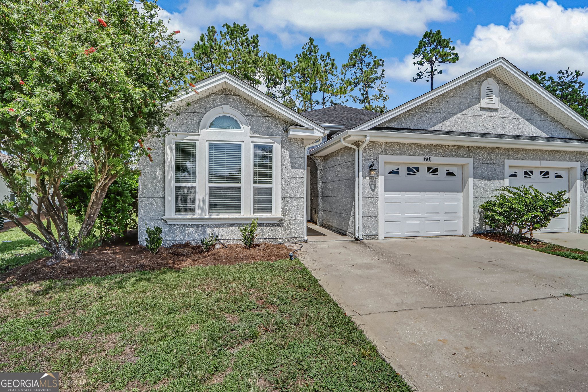 601 Eagle Boulevard Kingsland, GA 31548 - Photo 2 of 41 a front view of a house with a yard and garage