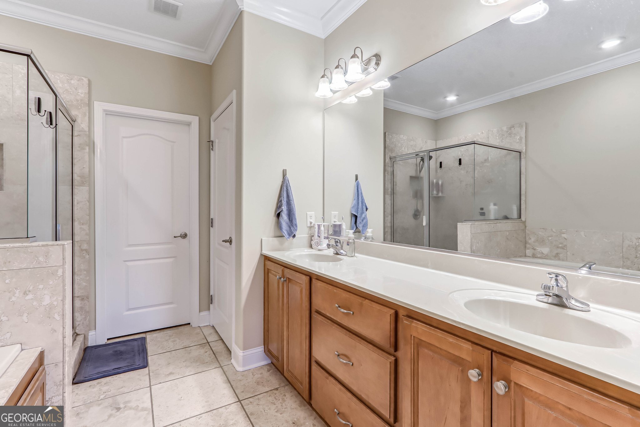 601 Eagle Boulevard Kingsland, GA 31548 - Photo 28 of 41 a bathroom with a double vanity sink a mirror and a shower