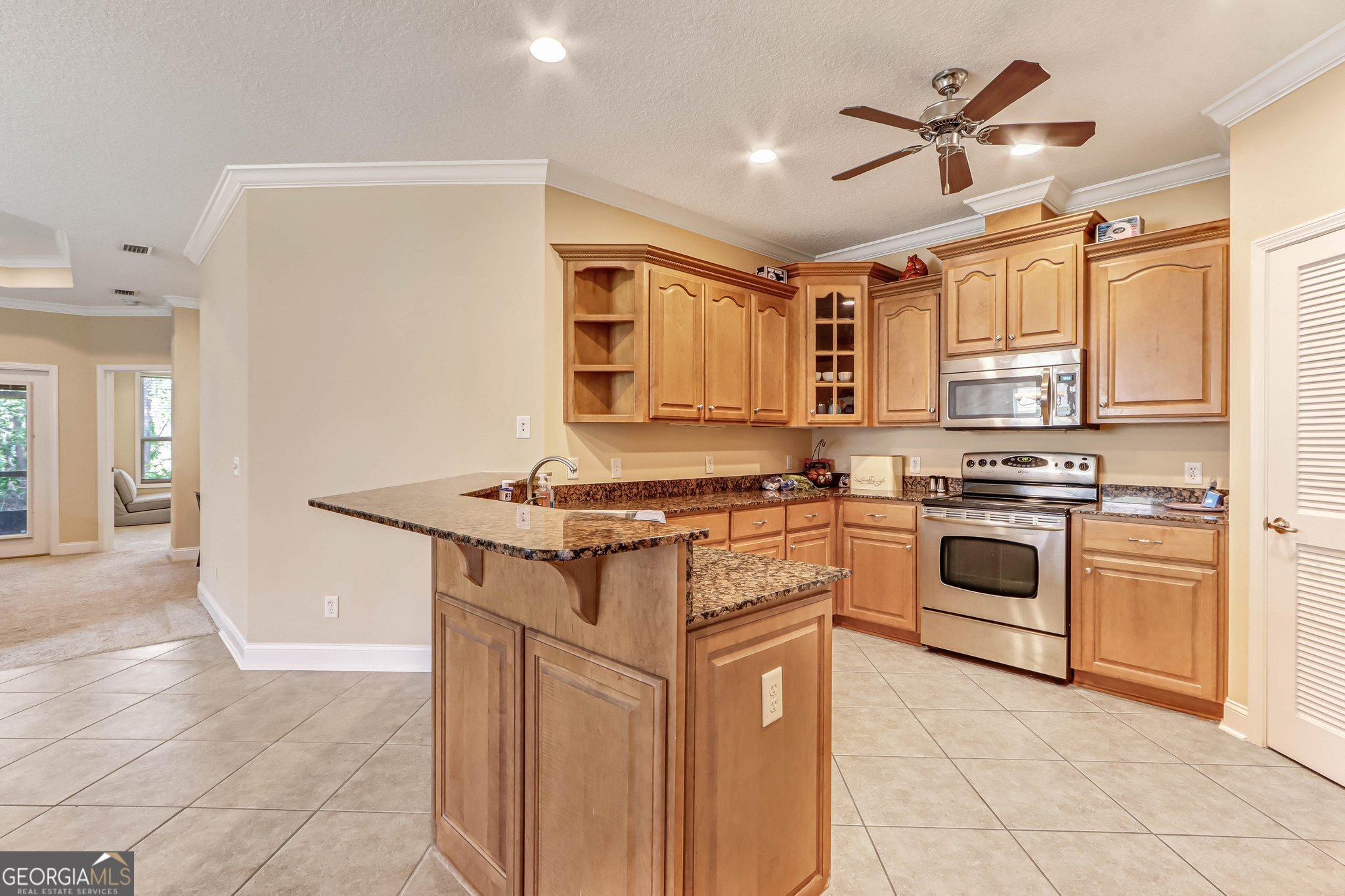 601 Eagle Boulevard Kingsland, GA 31548 - Photo 10 of 41 a kitchen with stainless steel appliances granite countertop a stove and a sink