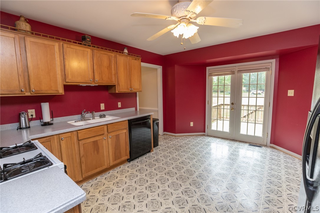 14005 Harrowgate Road Chester, VA 23831 - Photo 10 of 42 a kitchen with stainless steel appliances kitchen island granite countertop a stove a sink dishwasher and a microwave with wooden floor