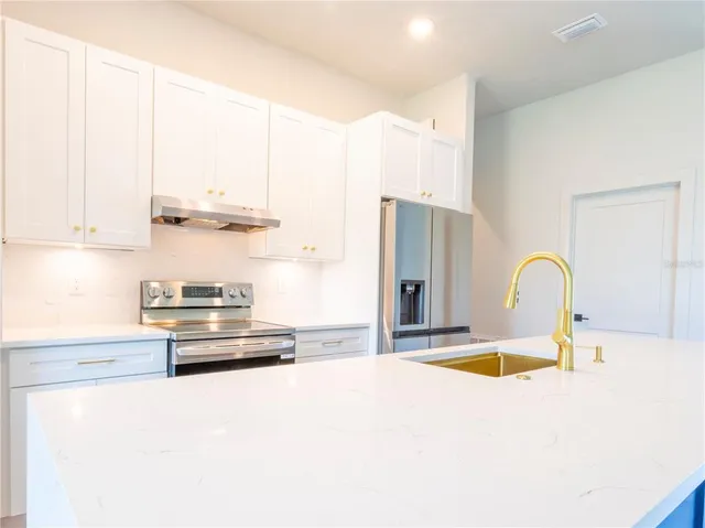 a kitchen with appliances and cabinets