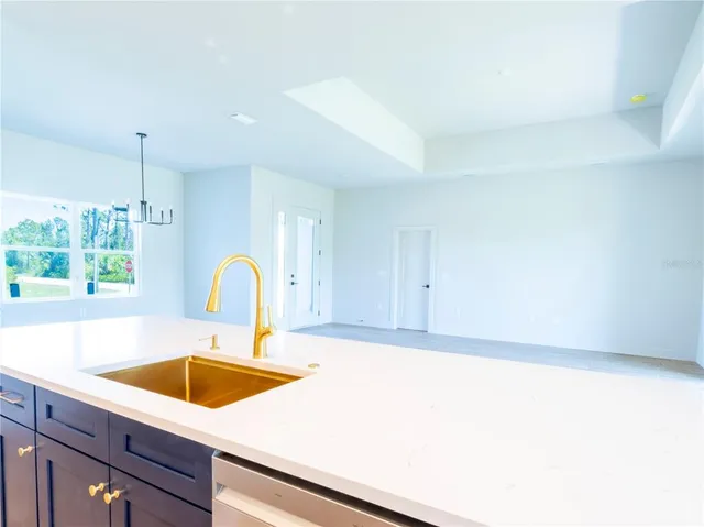 a kitchen with stainless steel appliances granite countertop a stove a sink and a hard wood floors