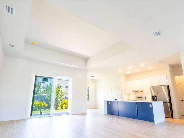 a bathroom with a tub a sink and wooden floor