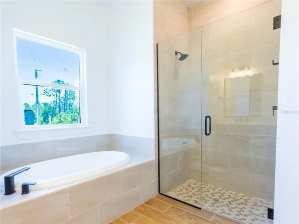 a bathroom with a tub and a shower