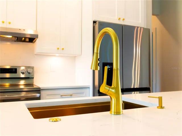 a stove top oven sitting inside of a kitchen