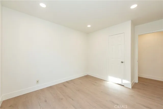 an empty room with wooden floor