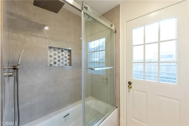 a bathroom with a bathtub and a shower