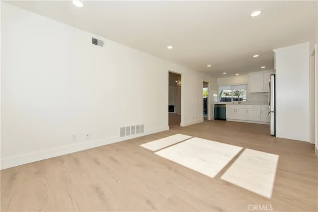 a view of kitchen with refrigerator and window