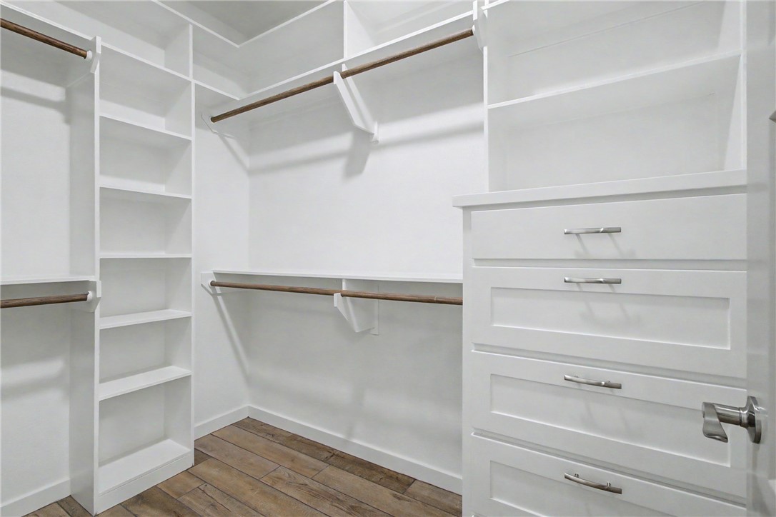 1403 Rochester Street Bryan, TX 77803 - Photo 10 of 19 Custom white closet system featuring multiple shelving units and wood-finish flooring