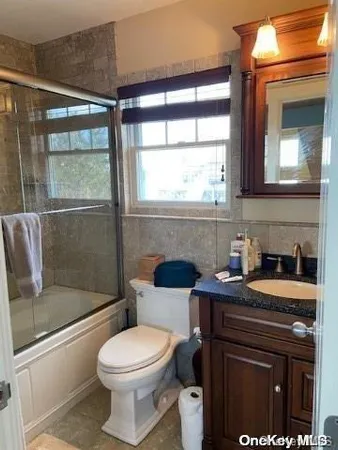 a bathroom with a sink a toilet and a shower