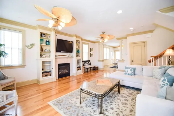 a living room with fireplace furniture and a flat screen tv