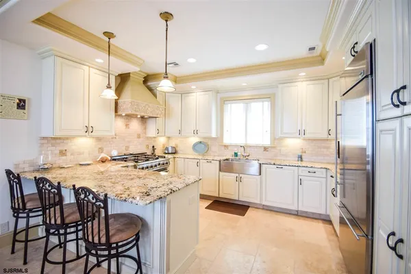 a kitchen with center island table and chairs