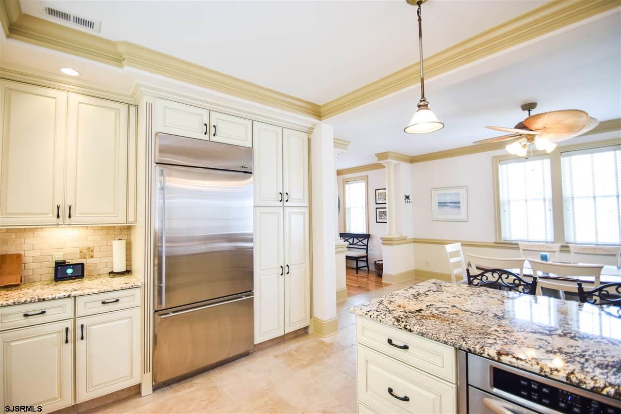 11 South 31st Avenue Longport, NJ 08403 - Photo 14 of 25 a kitchen with stainless steel appliances granite countertop a refrigerator a oven and white cabinets with wooden floor