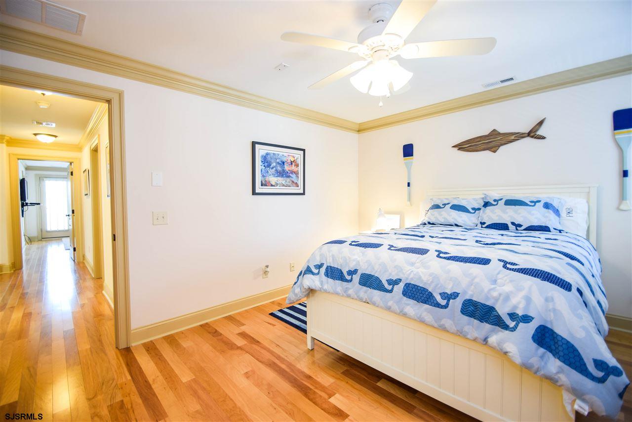 11 South 31st Avenue Longport, NJ 08403 - Photo 20 of 25 a bedroom with a bed and a chandelier
