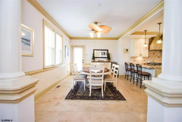 a living room with furniture a dining table and a large window