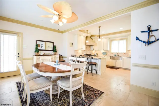 a dining room with wooden floor and a chandelier