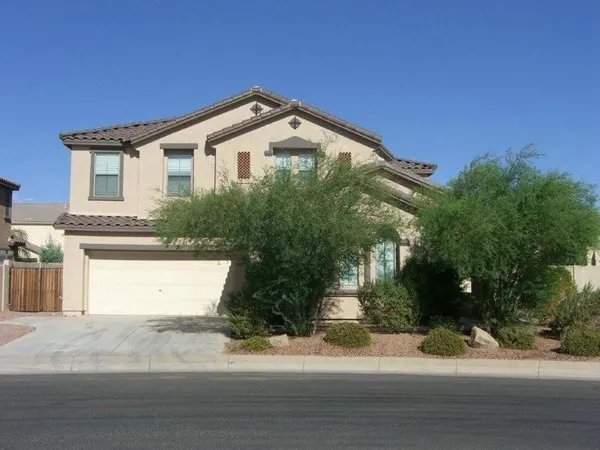 a view of a house with a yard and garage