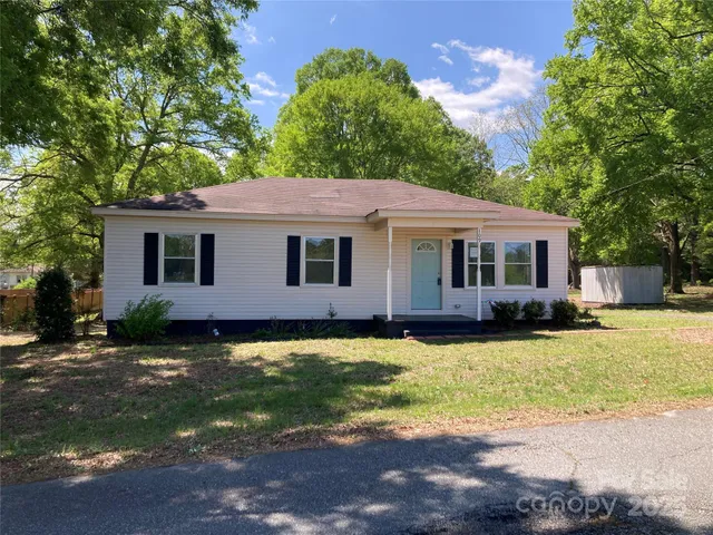 a front view of a house with yard and green space