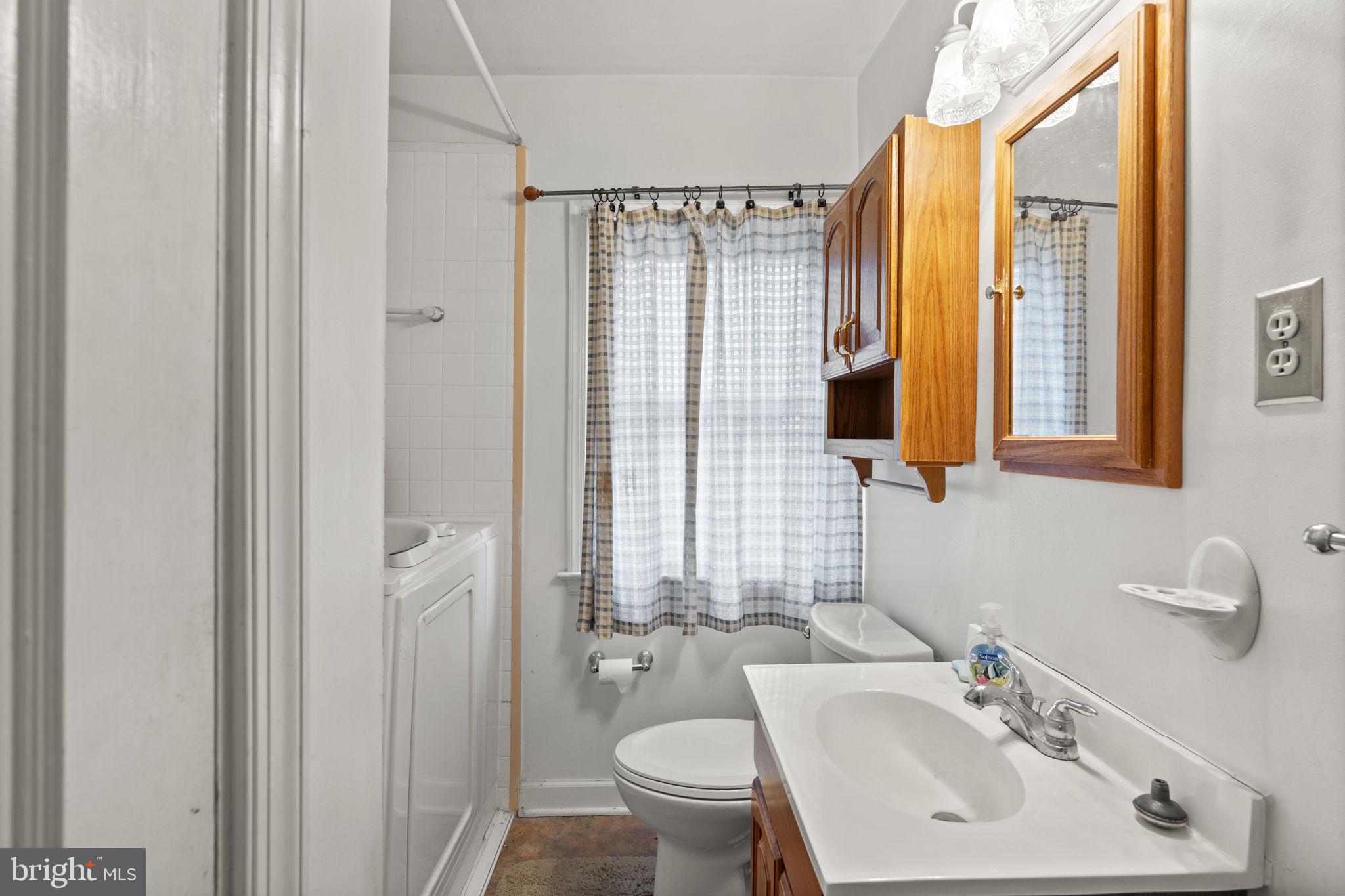 1870 Yakona Road Baltimore, MD 21234 - Photo 24 of 31 a bathroom with a sink a toilet and a mirror