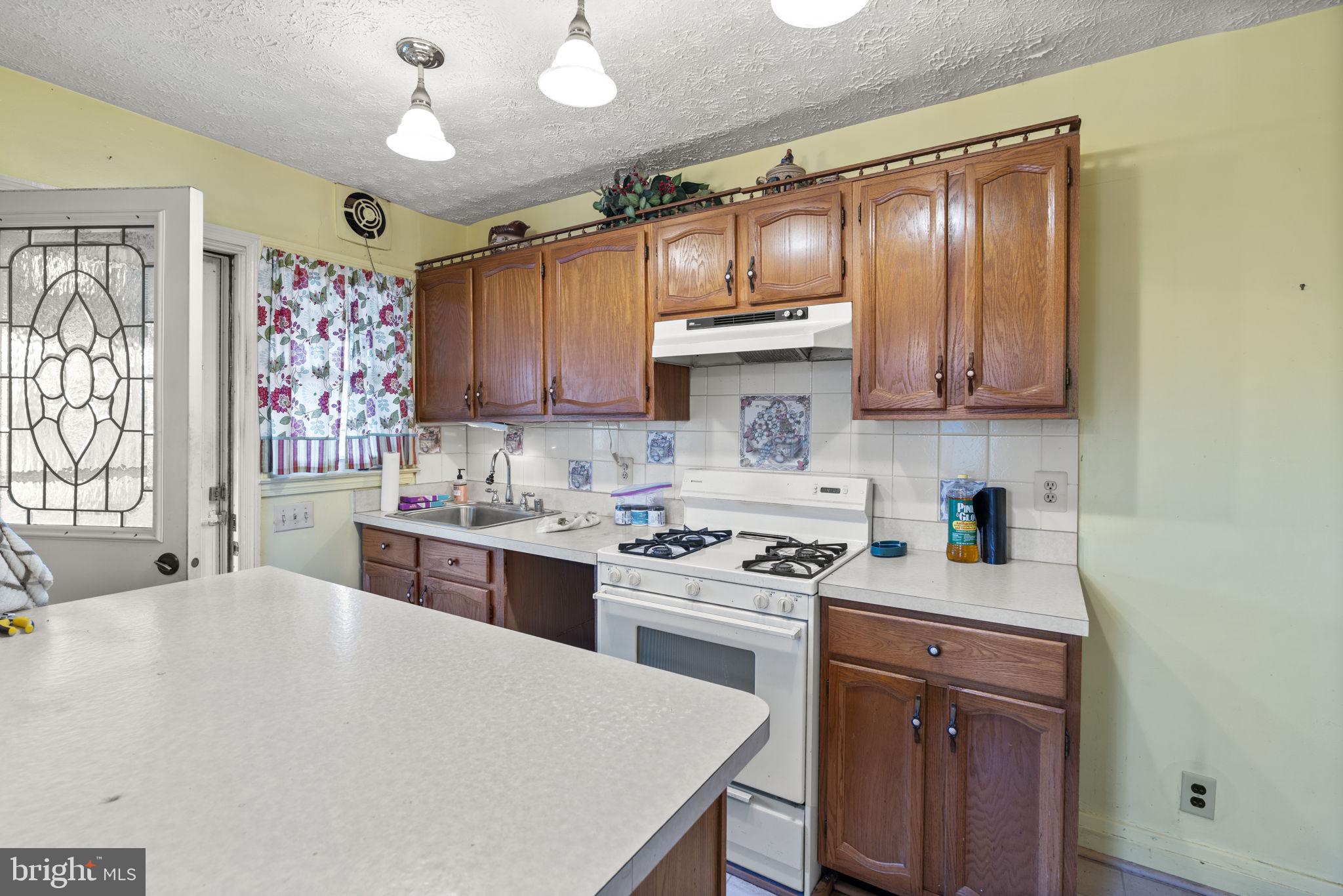 1870 Yakona Road Baltimore, MD 21234 - Photo 10 of 31 a kitchen with a stove a sink and cabinets
