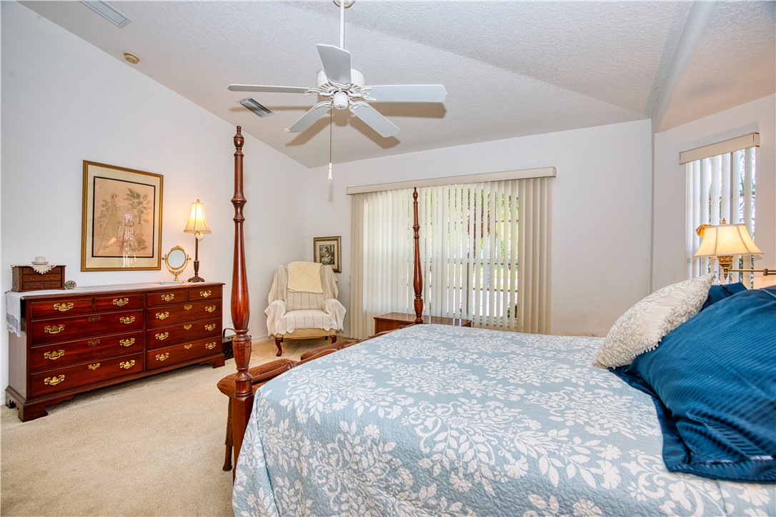 173 Easy Street Sebastian, FL 32958 - Photo 17 of 35 a bedroom with a bed and wooden floor