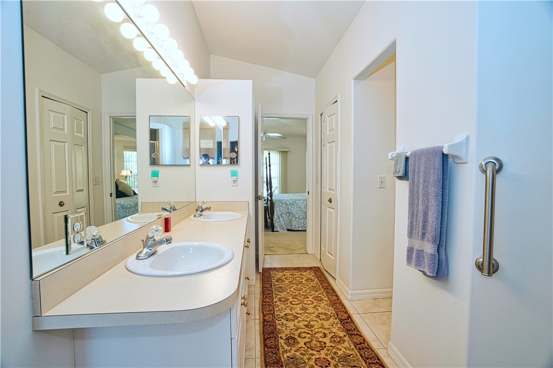 173 Easy Street Sebastian, FL 32958 - Photo 21 of 35 a en suite bathroom with a sink and mirror
