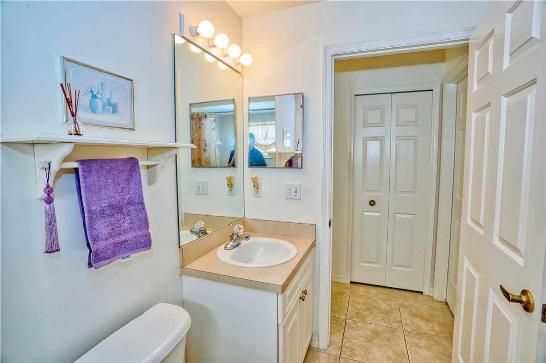 173 Easy Street Sebastian, FL 32958 - Photo 25 of 35 a bathroom with a sink mirror vanity and toilet