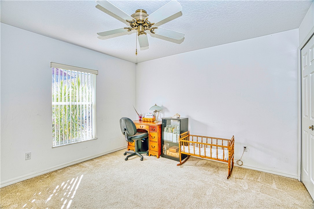 173 Easy Street Sebastian, FL 32958 - Photo 26 of 35 a view of a room with furniture a ceiling fan and a window