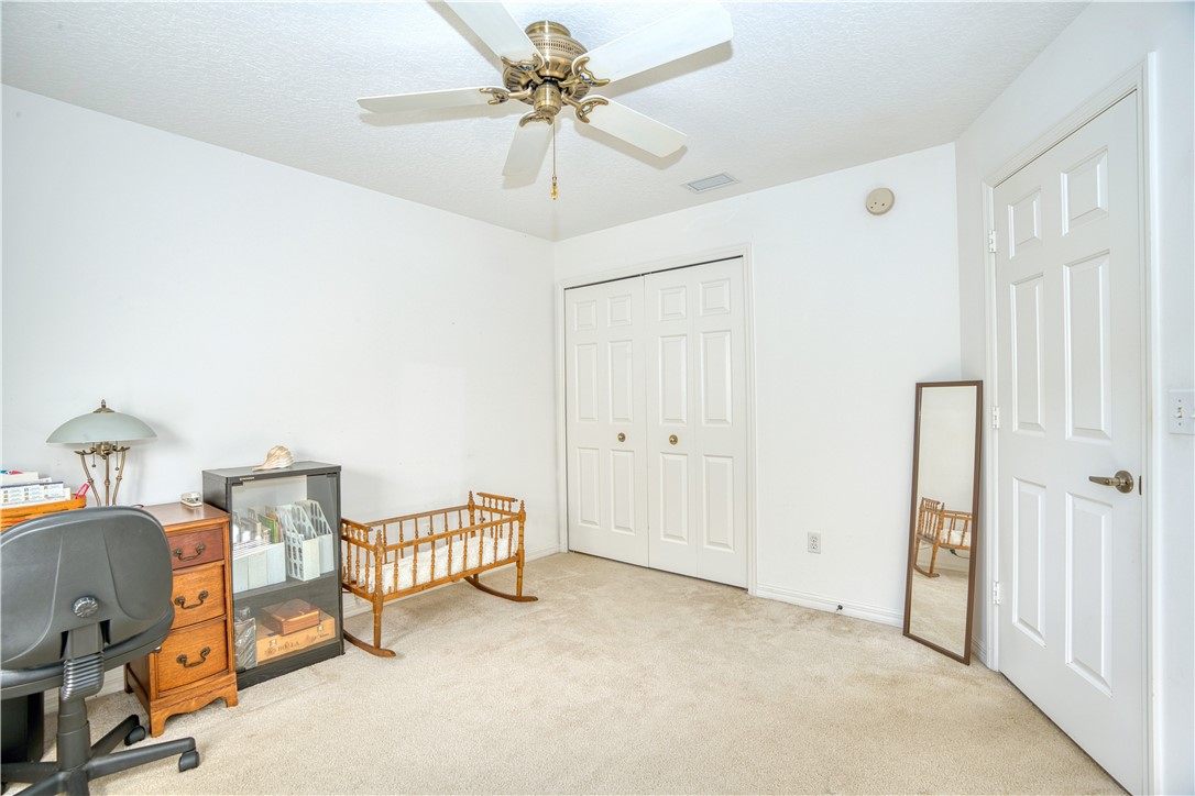 173 Easy Street Sebastian, FL 32958 - Photo 27 of 35 a view of a bedroom with window and a ceiling fan