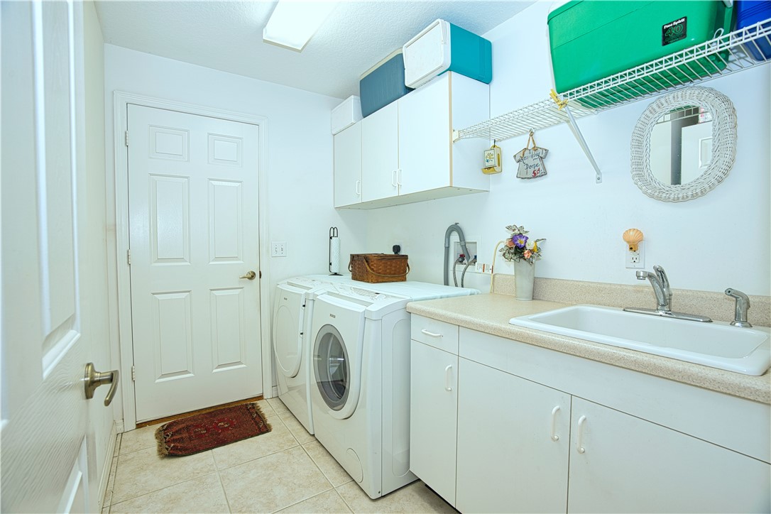 173 Easy Street Sebastian, FL 32958 - Photo 28 of 35 a utility room with sink dryer and washer