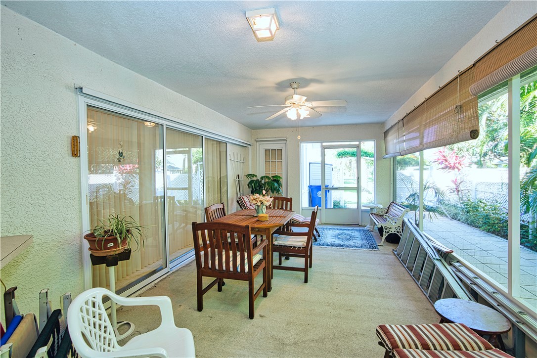 173 Easy Street Sebastian, FL 32958 - Photo 31 of 35 a dining room with furniture a rug and a floor to ceiling window