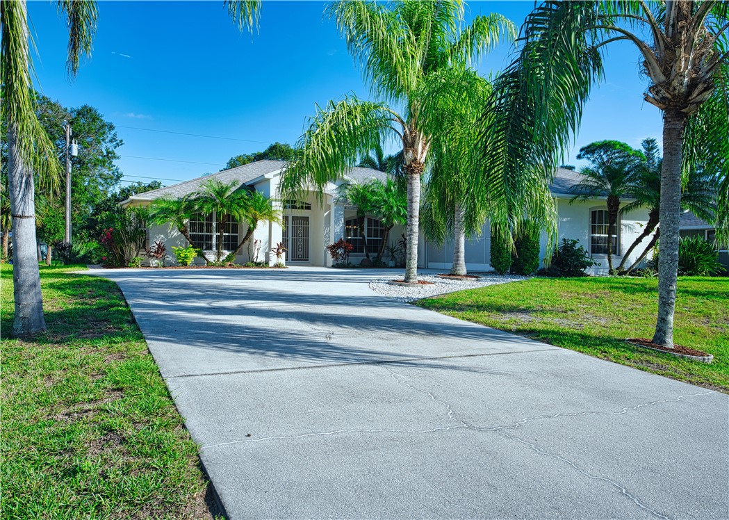 173 Easy Street Sebastian, FL 32958 - Photo 4 of 35 a house with palm tree in front of it