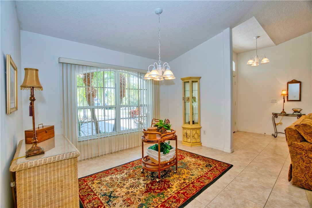 173 Easy Street Sebastian, FL 32958 - Photo 7 of 35 a living room with furniture and a chandelier