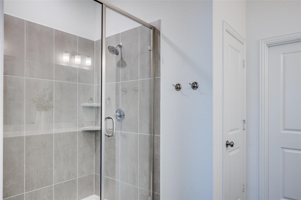 3718 Pelican Rst Way Arlington, TX 76005 - Photo 20 of 40 a bathroom with a glass shower door and a shower