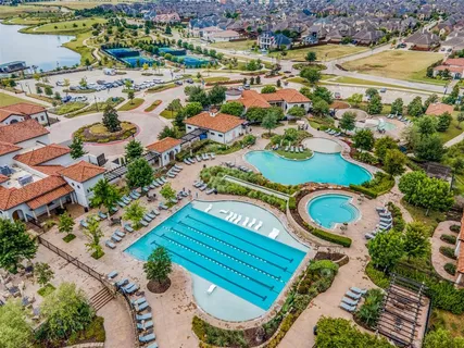 an aerial view of a residential houses with outdoor space