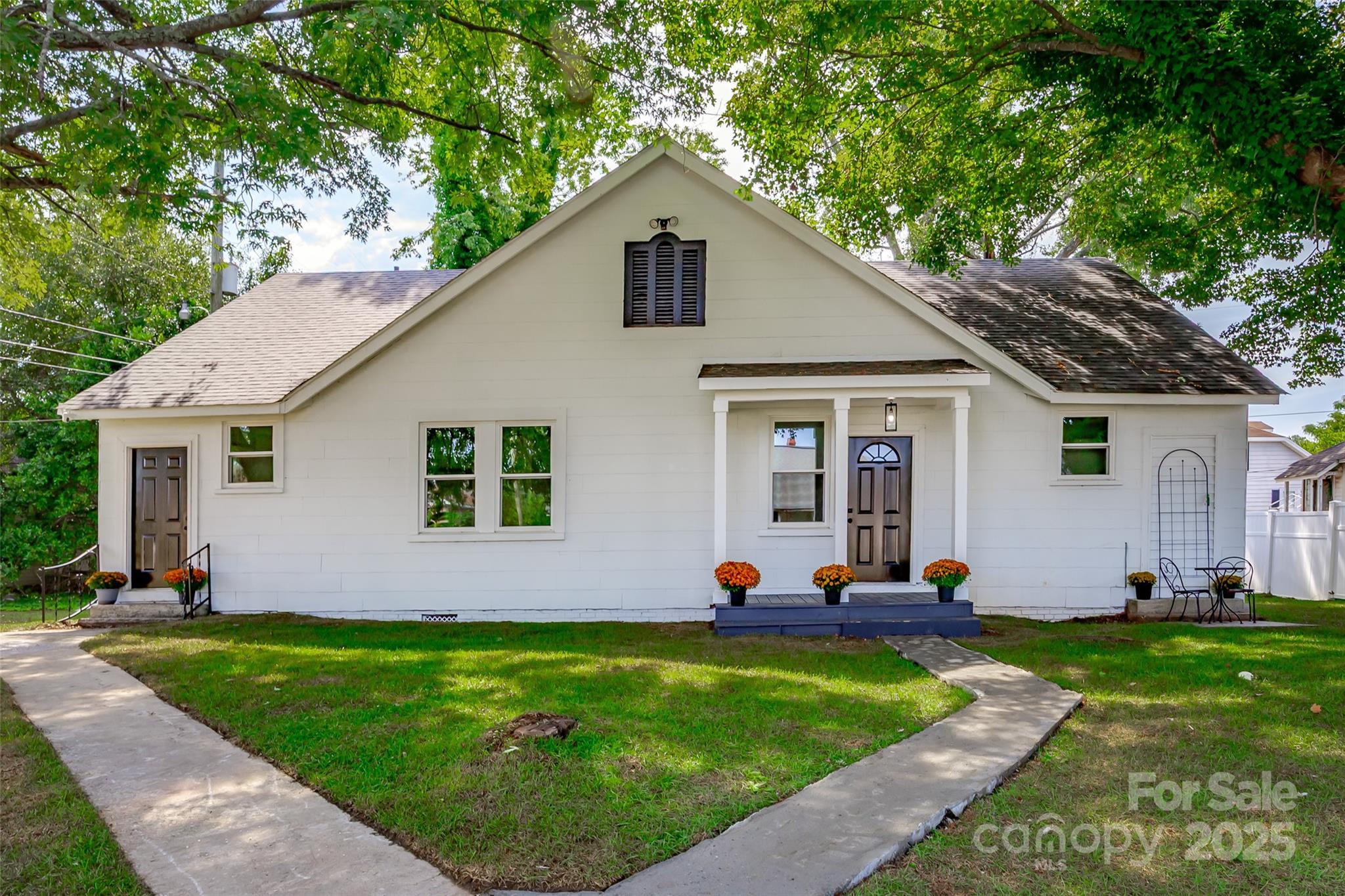 a view of a house with backyard sitting area and garden