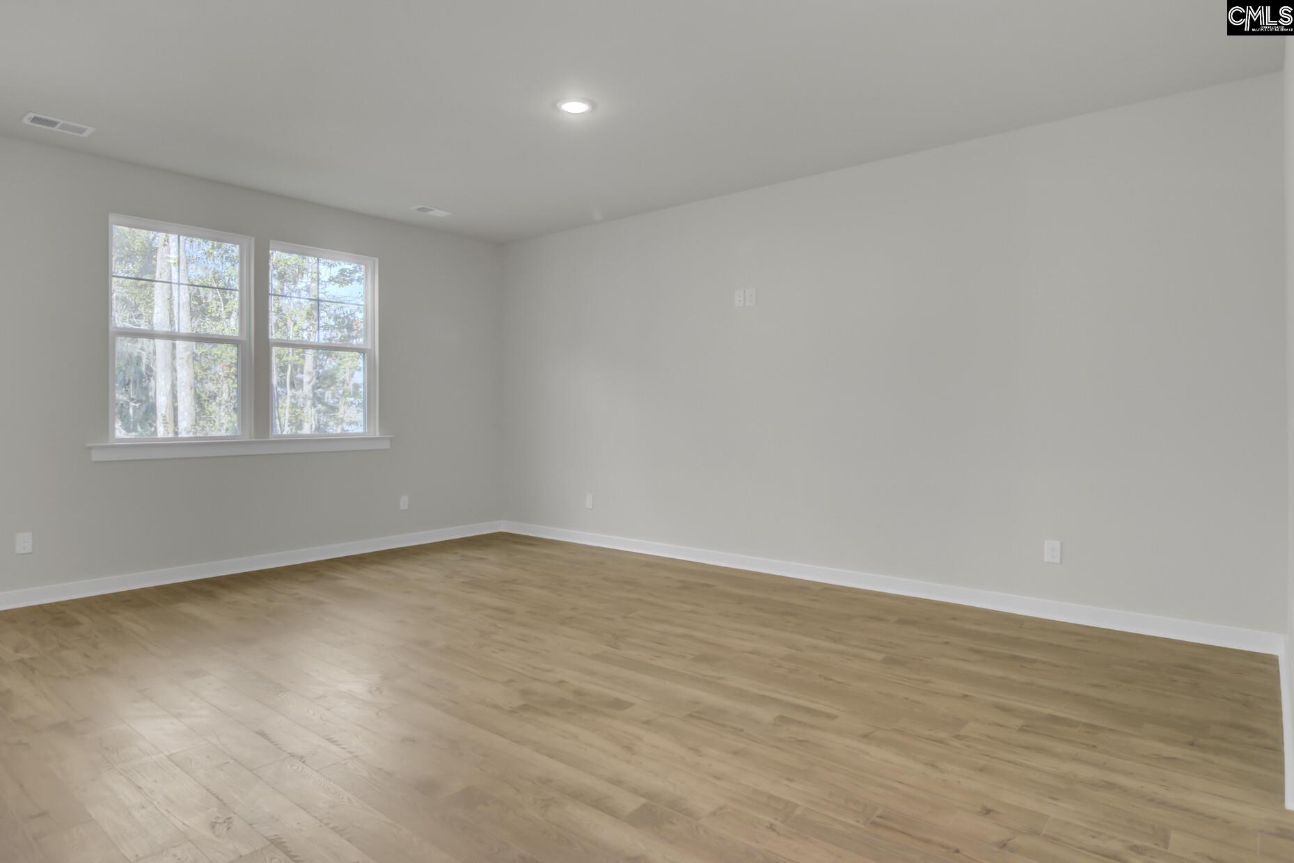 320 Brass Billion Path Lexington, SC 29073 - Photo 8 of 39 an empty room with wooden floor and windows