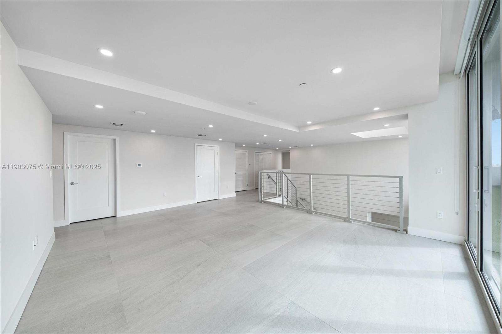 555 Northeast 34th Street, Unit PH3 Miami, FL 33137 - Photo 13 of 51 an empty room with wooden floor and windows