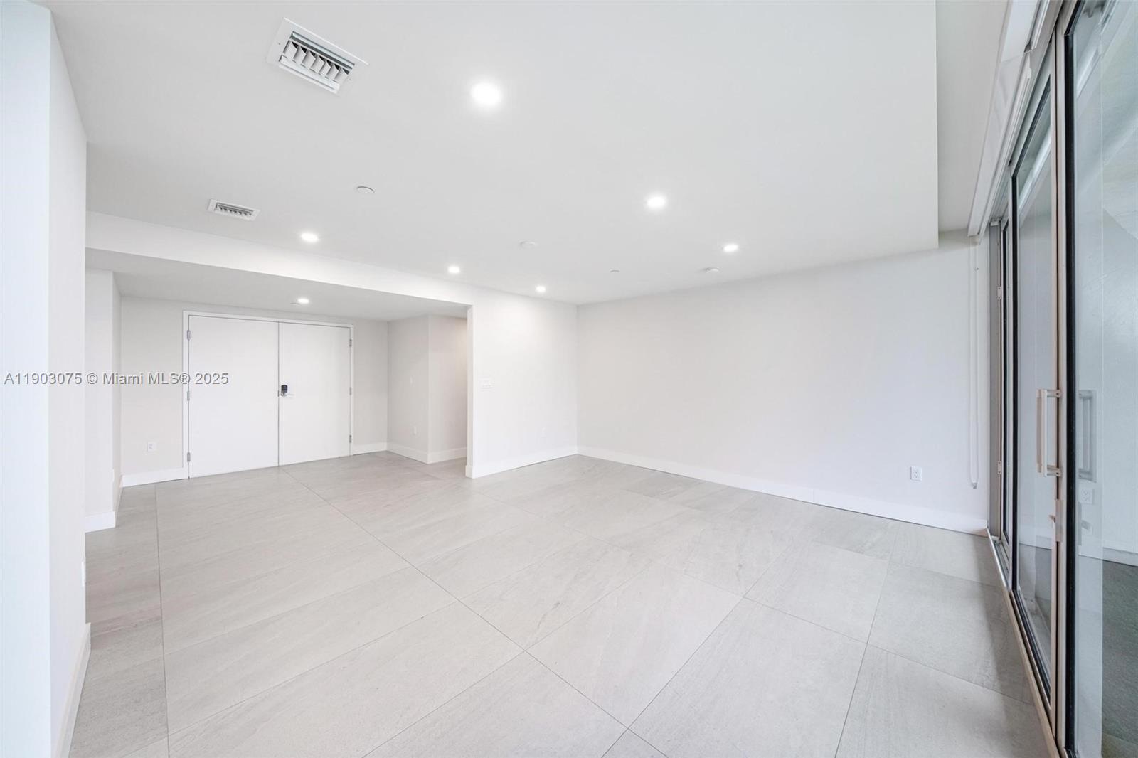 555 Northeast 34th Street, Unit PH3 Miami, FL 33137 - Photo 24 of 51 an empty room with wooden floor and windows