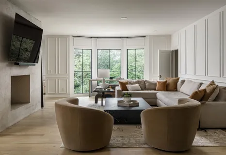 a living room with furniture a flat screen tv and a fireplace