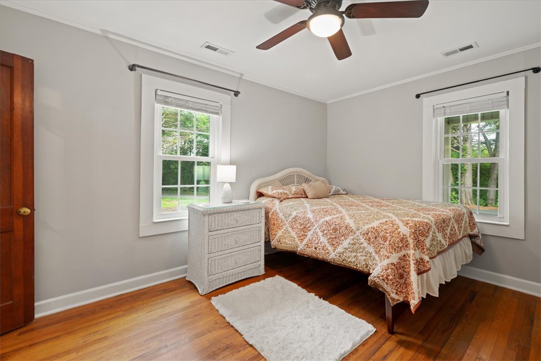 174 Holliday Road Six Mile, SC 29682 - Photo 28 of 49 Original Hardwood floors and dual windows brighten this inviting Primary bedroom.