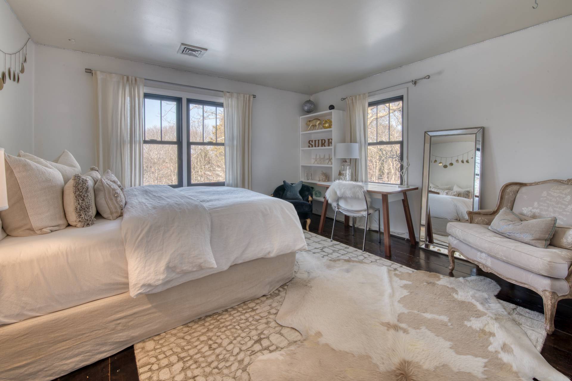 Undisclosed Address Sag Harbor, NY 11963 - Photo 13 of 23 a bedroom with a large bed and a large window
