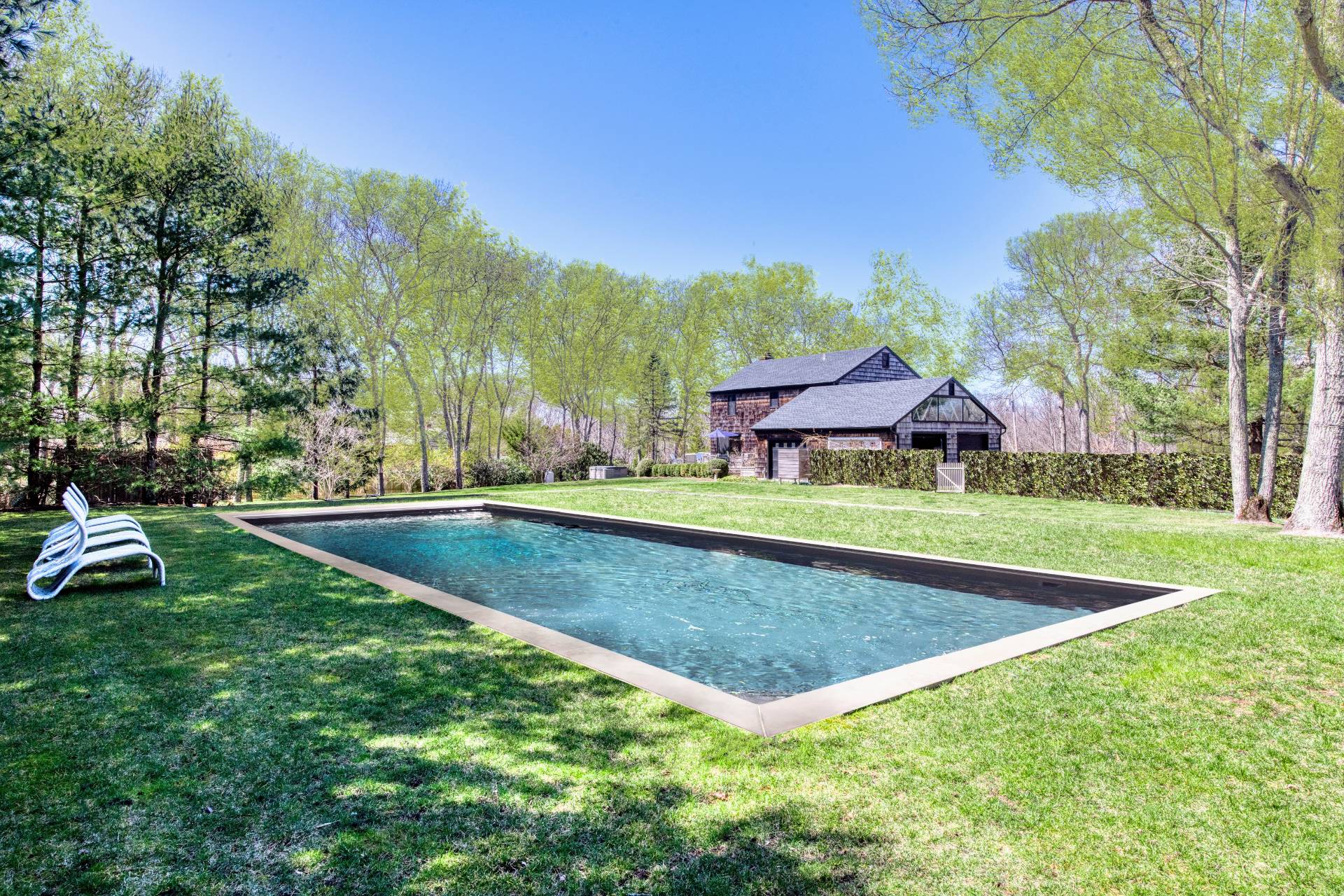Undisclosed Address Sag Harbor, NY 11963 - Photo 3 of 23 a view of a house with swimming pool and yard