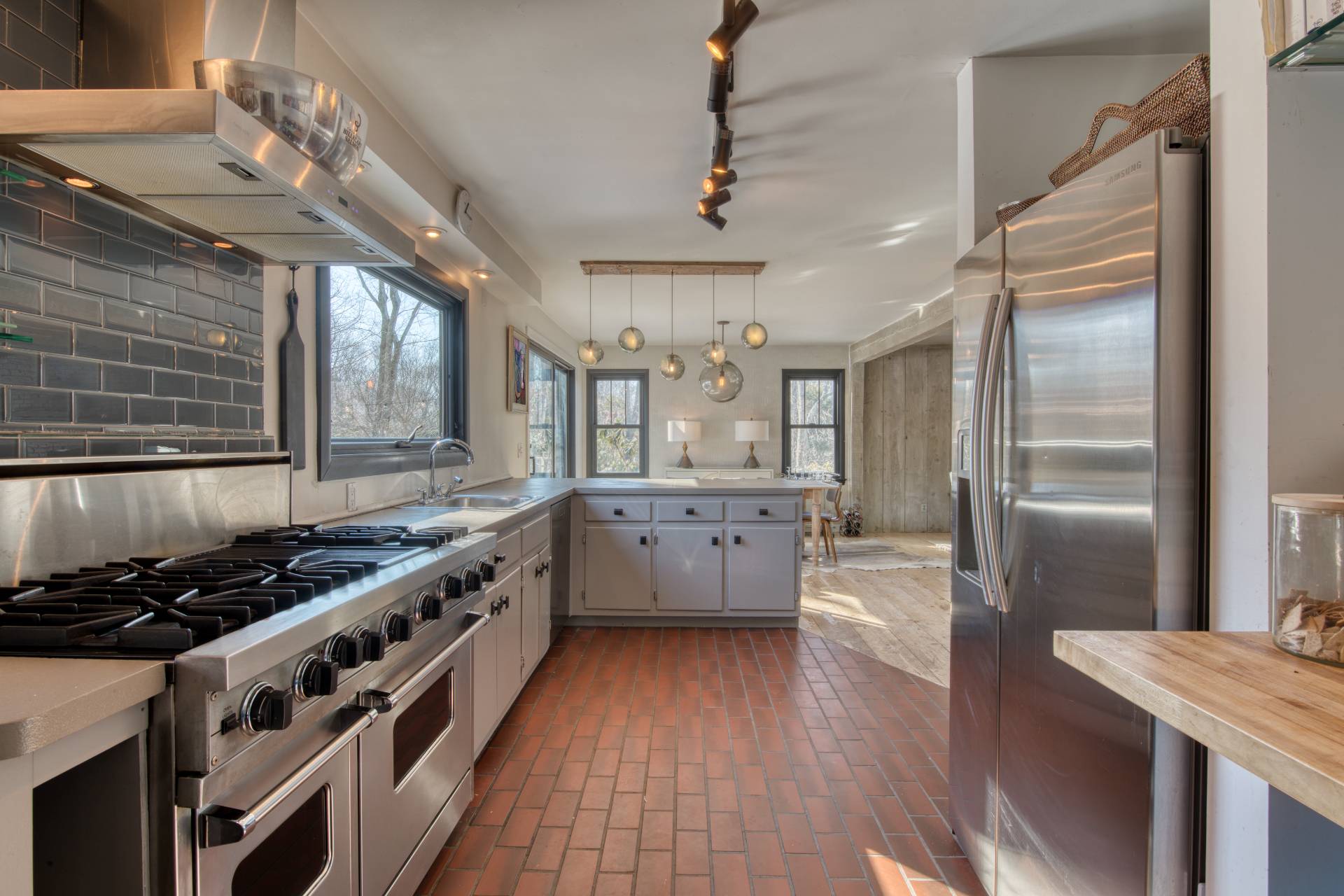 Undisclosed Address Sag Harbor, NY 11963 - Photo 8 of 23 a kitchen with stainless steel appliances granite countertop a stove and a refrigerator