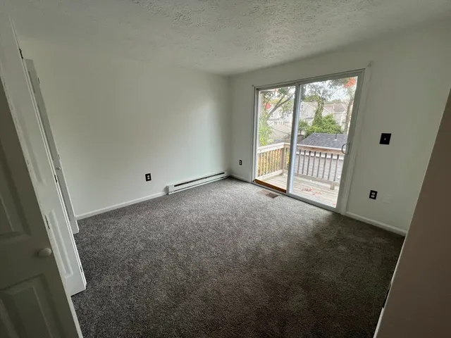 a living room with furniture gym equipment and a large window