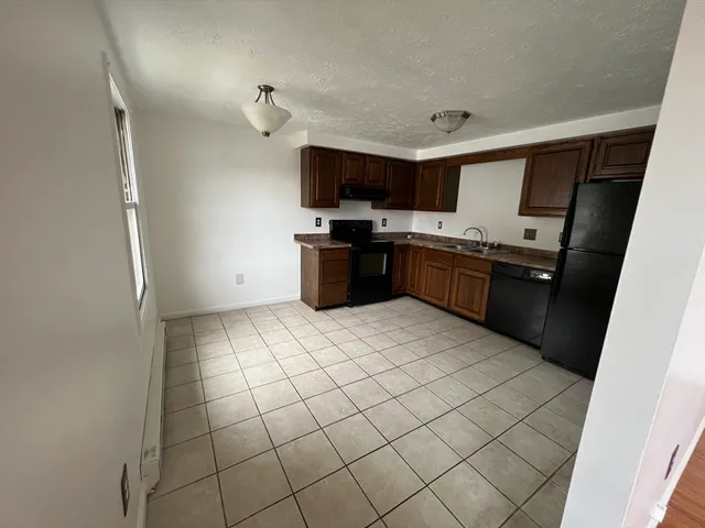 a kitchen with stainless steel appliances granite countertop a sink and a stove top oven