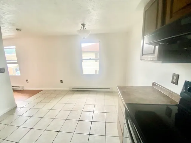 a view of a kitchen with a sink dishwasher and a stove top oven
